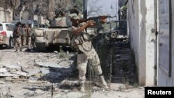 A member of Libyan National Army fires a weapon during clashes with Islamist militants in the militants' last stronghold in Benghazi, Libya, July 6, 2017.