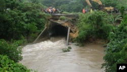 Emergency crews repairing a bridge damaged in floods near the town of Singatoka, Fiji, March 31, 2012.