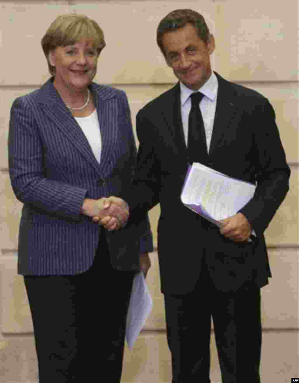 German Chancellor Angela Merkel, left, and France's President Nicolas Sarkozy, right, shake hands after their joint press conference at the Elysee Palace, Tuesday Aug. 16, 2011. (AP Photo/Michel Euler)