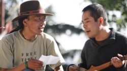 The filmmaker, Ngawang Choephel, right, and a friend, prepare a traditional song for 'Tibet in Song'