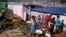 Children paint a shack with white fire retardant paint as part of their contribution to International Nelson Mandela day celebrating former South African president Mandela birth day in the township of Nomzamo, South Africa, July 18, 2015. 