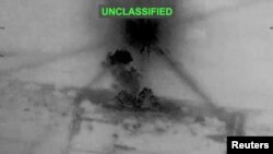 Smoke rises from explosions at an unknown location, following what U.S. Central Command (CENTCOM) said were strikes on Iran in response to an Iranian drone strike on a cargo ship in the Strait of Hormuz