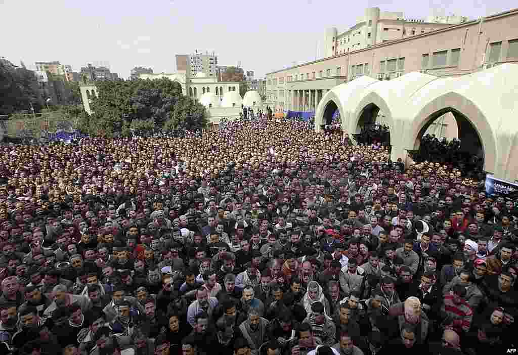 Thousands of Egyptian Christians watch on a giant screen the funeral of Pope Shenouda oustide St. Mark Coptic Orthodox Church in Cairo. (AP)