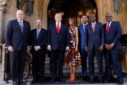 U.S. President Trump and first lady Melania Trump pose before a meeting with St Lucia Prime Minister Allen Chastanet, Dominican Republic President Danilo Medina, Jamaica Prime Minister Andrew Holness, Haiti President Jovenel Moise and Bahamas PM.