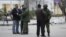 Armed men check journalists documents around the regional parliament building in the Crimean city of Simferopol March 1, 2014.