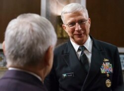 FILE - Navy Vice Adm. Craig Faller, right, talks with Senate Armed Services Committee ranking member Sen. Jack Reed, D-R.I., after a hearing on Capitol Hill in Washington, Sept. 25, 2018.