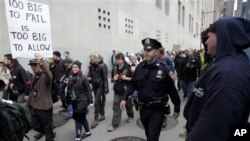 'Occupy Wall Street' protesters march to a Verizon office to support employees there who are picketing in New York, Tuesday, Oct. 4, 2011.