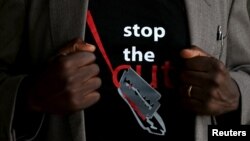 FILE - A man's T-shirt reads "Stop the Cut" referring to Female Genital Mutilation during a social event advocating against the practice at the Imbirikani Girls High School in Imbirikani, Kenya, April 21, 2016.