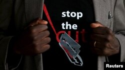 FILE - A man's T-shirt reads "Stop the Cut" referring to Female Genital Mutilation during a social event advocating against such harmful practices at the Imbirikani Girls High School in Imbirikani, Kenya, April 21, 2016.