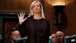 Kirstjen Nielsen is sworn in at a hearing on her nomination to be Department of Homeland Security Secretary, by the Senate Homeland Security and Governmental Affairs committee, Nov. 8, 2017, in Washington.