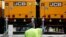 An employee loads lighting towers manufactured by JC Bamford Excavators Ltd. (JCB) at the the JCB France headquarters in Sarcelles, near Paris, France, May 22, 2017. 