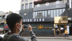 A man wearing a face mask takes pictures of a temporary closed dance club in Seoul, South Korea, Sunday, May 10, 2020. South Korea on Friday advised nightclubs and similar entertainment venues to close for a month and may delay the reopening of…