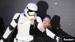 Carrie Fisher poses for cameras as she arrives at the European Premiere of Star Wars, The Force Awakens in Leicester Square, London, December 16, 2015.