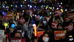 Participants gather to stage a rally demanding South Korean President Yoon Suk Yeol's impeachment, in front of the headquarters of the ruling People Power Party in Seoul, South Korea, Dec. 10, 2024.