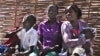 Children wait for their mothers at the Antenatal Clinic in South Sudan. (VOA - H. McNeish)