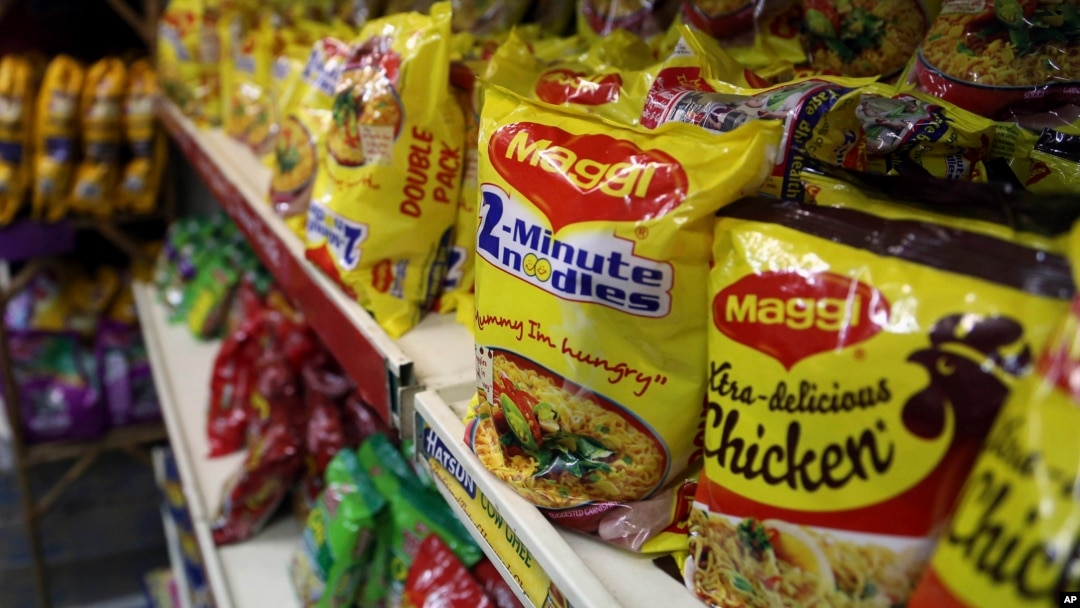 FILE - Packaged food with "Maggi" sign on it are displayed at a grocery store in Bangalore, India, June 5, 2015. 