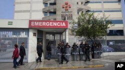 Riot police stand guard in front of the Centenario clinic where Peru's former President Alberto Fujimori is hospitalized, in Lima, Peru, Oct. 4, 2018. 
