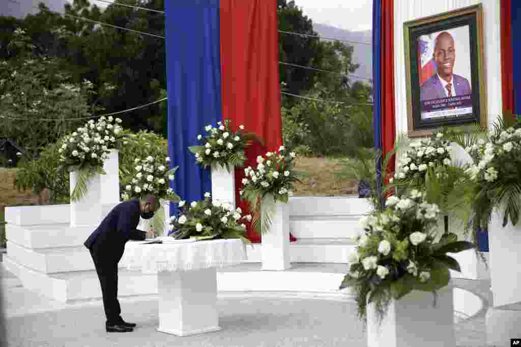 A man signs a signature book during a memorial ceremony for late Haitian President Jovenel Moise at the National Pantheon Museum in Port-au-Prince.
