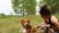 Brittney Johnson got her dog Mumford shortly after buying her Minnesota farm. (E.Sarai/VOA)