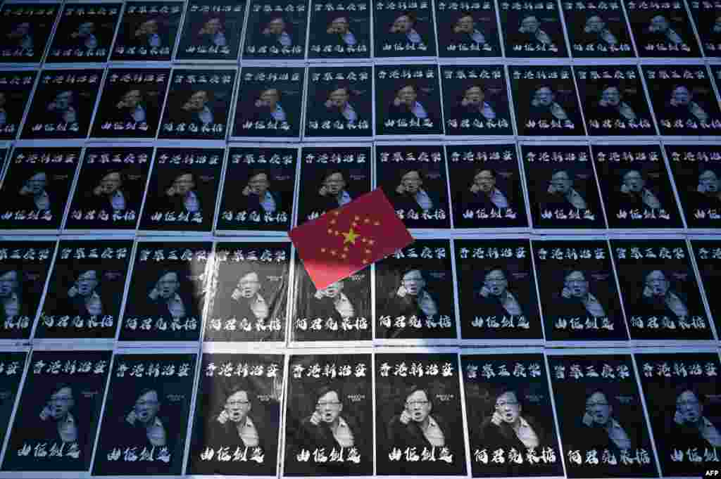 Posters of controversial pro-Beijing lawmaker Junius Ho are seen plastered onto paving stones in the grounds of the Chinese University of Hong Kong (CUHK), in Hong Kong.