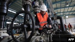 A Palestinian employee works at a desalination plant during the inauguration of the first phase of the project on Jan. 19, 2017, in Deir el-Balah in central Gaza.