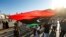 FILE - An elderly man waves a Libyan national flag during a demonstration in the Martyrs' Square in the centre of the Libyan capital Tripoli, currently held by the UN-recognised Government of National Accord (GNA), on June 21, 2020.