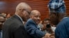 President of Interim Regional Administration of Tigray Getachew Reda, center, and Chairman of Tigray People's Liberation Front Debretsion Gebremichael, left, shake hands with Former President of Nigeria Olusegun Obasanjo at the AU Headquarters in Addis Ababa on Feb. 16, 2025. 