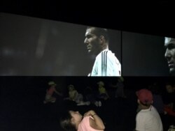 Children watch star player Zinedine Zidane of Algerian descent in replay of 1998 French World Cup victory. (Lisa Bryant/VOA)