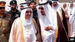 FILE - King Salman of Saudi Arabia (R) welcomes Kuwaiti Emir Sabah Al Ahmed Al Sabah upon his arrival to Riyadh Airbase before the opening of Gulf Cooperation Council summit in Riyadh, Saudi Arabia, May 2015.