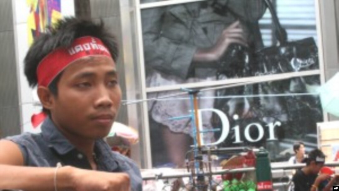 A young red shirt supporter sits at the movement's protest site in downtown Bangkok