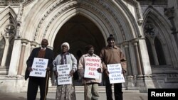 Wambugu Nyingi, Jane Muthoni, Paul Nzili and Ndiku Mutua (L-R) stand outside the High Court in London April 7, 2011. 