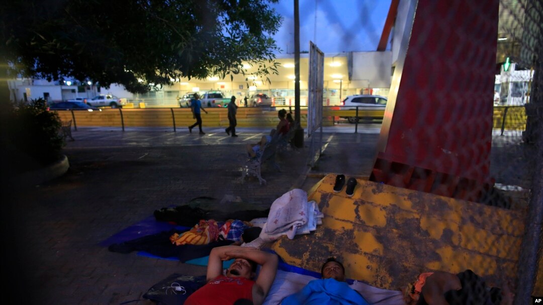 A small group of migrants waiting to seek asylum sleeps at the entrance to the Puerta Mexico international bridge in Matamoros, Mexico, June 28, 2019.