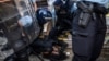 Portuguese police detain a woman who was protesting against the demonstration against "uncontrolled immigration" called by Portuguese far-right party Chega in Lisbon, Sept. 29, 2024. 