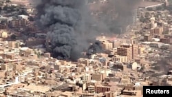 FILE —An aerial view of the black smoke and flames at a market in Omdurman,Khartoum North, Sudan, May 17, 2023