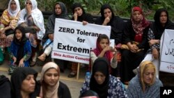 FILE - Pakistanis from Shi'ite community block the main highway in Islamabad, Pakistan, July 22, 2016 while demanding government to provide their community security. 