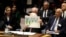 Palestinian President Mahmoud Abbas holds up a document as he speaks during a Security Council meeting at United Nations headquarters.