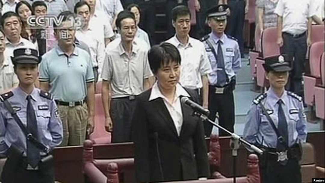 Gu Kailai (C), wife of ousted Chinese politician Bo Xilai, stands at the defendant's dock during her trial at Hefei Intermediate People's Court in this still image taken from video, August 20, 2012. 