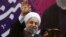 FILE - Iranian President Hassan Rouhani, center, waves to his supporters during a campaign rally for the May 19 presidential election in Tehran, Iran, May 9, 2017. 