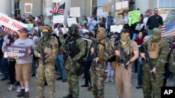 FILE - People, including activists with the Boogaloo movement, rally at the State House in Concord, New Hampshire, May 2, 2020, in a protest unrelated to the George Floyd demonstrations.