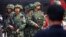 FILE - Paramilitary policemen stand guard in Urumqi, Xinjiang Uighur Autonomous region, in May 2014. The Islamic State may be reaching out to the Muslim Uighur populations, as al-Qaida did in the past.