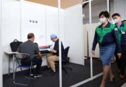 Tokyo Governor Yuriko Koike inspects a vaccination of COVID-19 at the Tokyo Metropolitan Government office in Tokyo as Tokyo Metropolitan Government started vaccination for the persons involved in the Olympic Games, June 18, 2021.