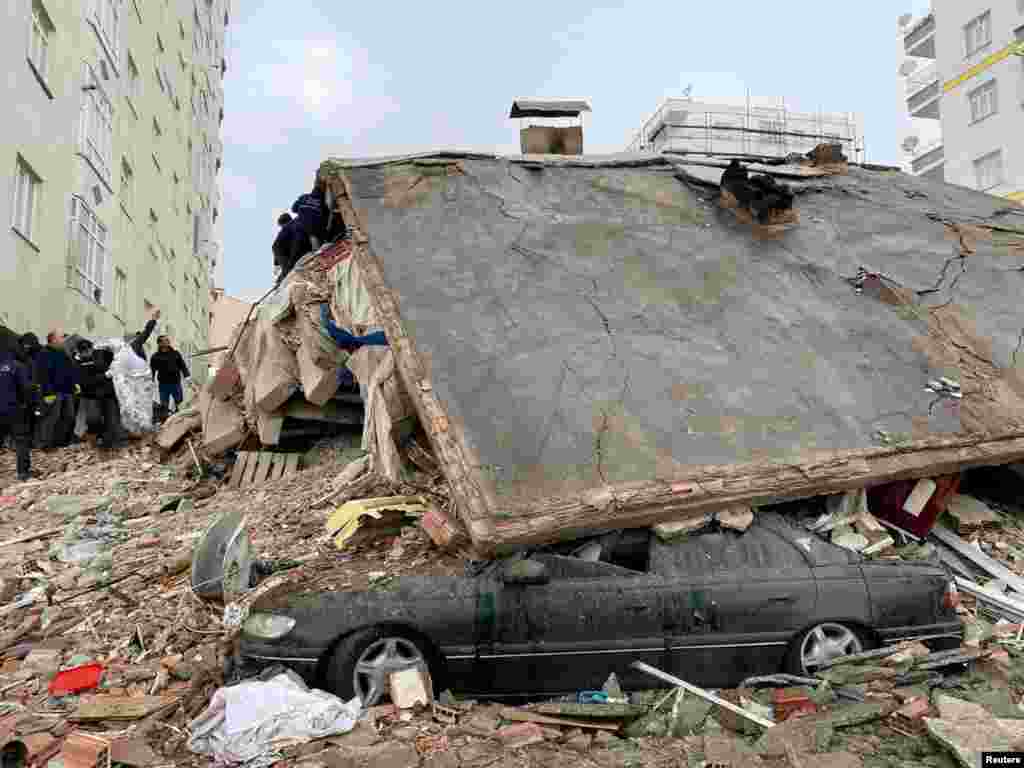 People search through rubble following an earthquake in Diyarbakir, Turkey, Feb. 6, 2023.&nbsp;