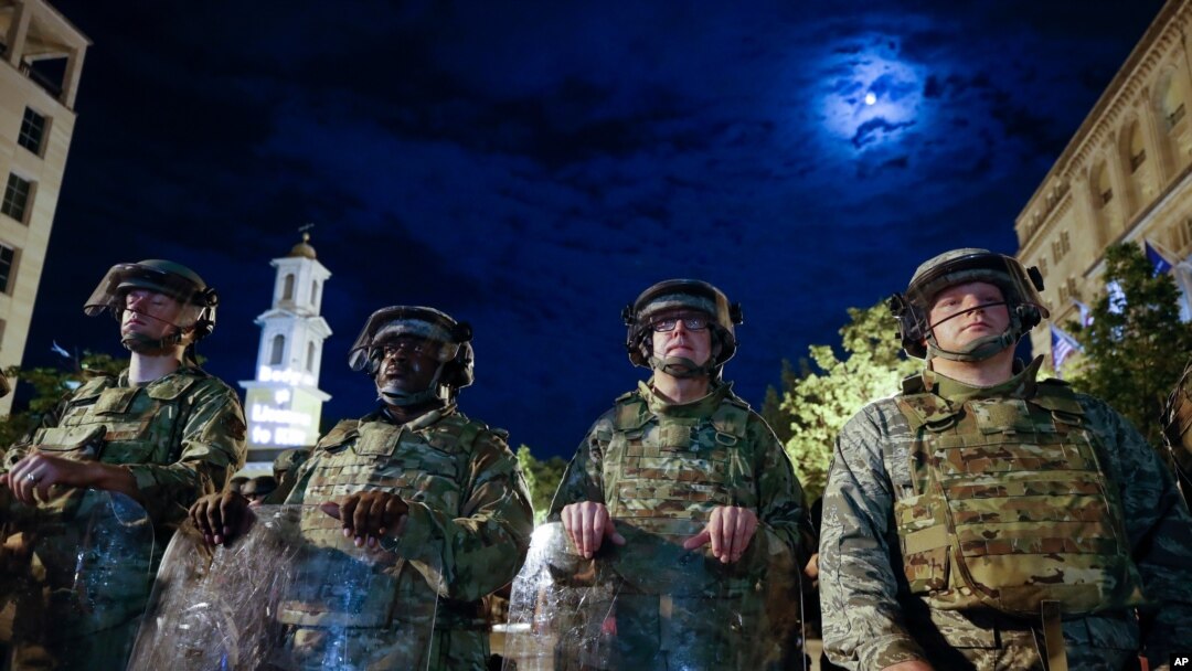 Utah National Guard soldiers stand on a police line as demonstrators gather to protest the death of George Floyd, June 4, 2020, near the White House in Washington. 