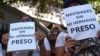 FILE - People protest outside the Justice Palace courts for the release of those detained during a government crackdown on antigovernment protests, in Caracas, Venezuela, on Nov. 7, 2024. The signs read in Spanish "Christmas without my detained brother."