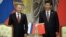 Russia's President Vladimir Putin, and China's President Xi Jinping, right, smile during signing ceremony in Shanghai, China on May 21, 2014.