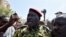 Lieutenant-Colonel Yacouba Issaac Zida (C) leaves the Place de la Nation square on Oct. 31, 2014 in Ouagadougou after the resignation of Burkina Faso's President Blaise Compaore.