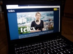 FILE - Veronika Munk, editor-in-chief of the independent, crowdfunded Hungarian news site Telex, is seen on the site's web page on a laptop in Budapest, Sept. 15, 2020.