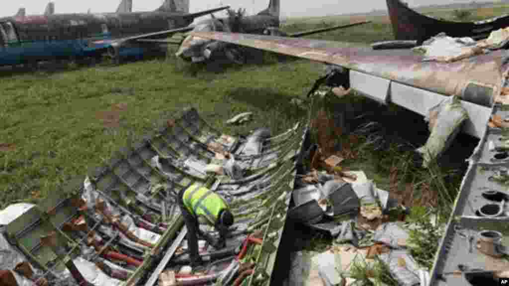 A worker dismantles the wing of an abandoned airplane at Murtala Muhammed International Airport in Lagos, Nigeria.