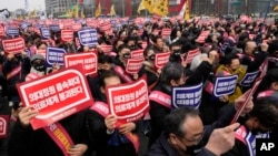FILE - Doctors stage a rally against a government plan to increase enrollments at medical schools, in Seoul, South Korea, on March 3, 2024. Some senior doctors announced on March 12 that they may join the protracted strike by thousands of junior doctors.