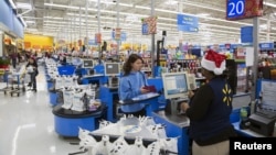 FILE - US customer shops at Walmart, which has warned along with other major US businesses, that prices for shoppers will rise due to higher tariffs on goods from China. 